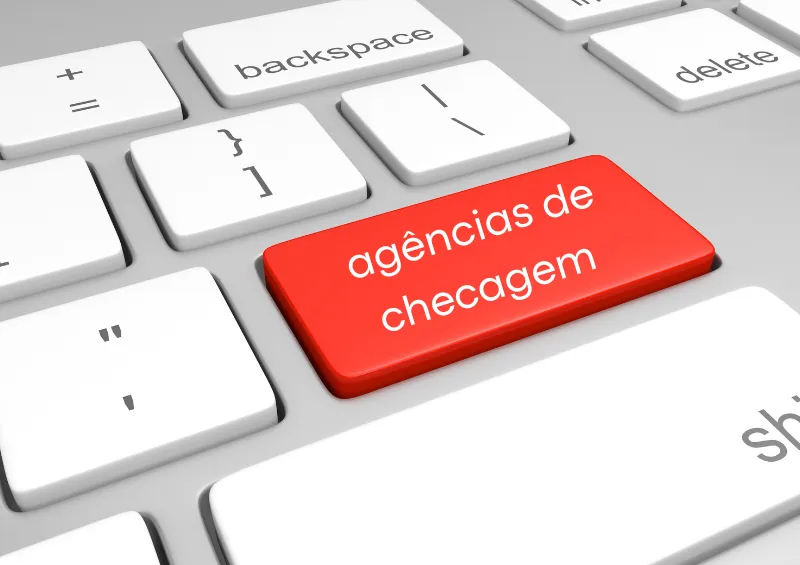 Teclado branco com tecla vermelha escrita ageência de checagem
