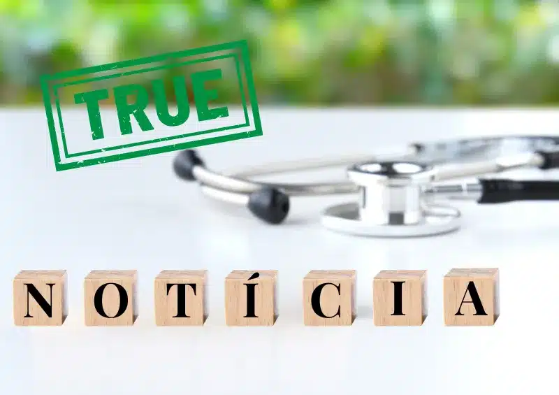 estetoscópio em cima da mesa com a palavra notícia escrita em bloquinhos e verdade em inglês escrita em cima